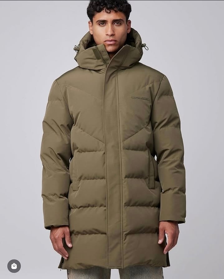 Man wearing olive green quilted puffer jacket